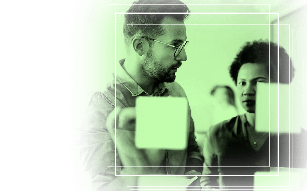 Manufacturing professional analyzing data insights on multiple screens